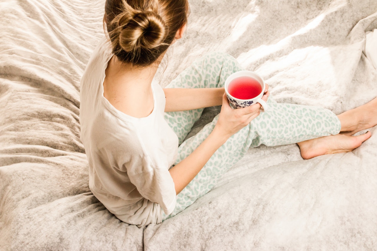 girl with fruit tea sitting on bed-Simply Shine